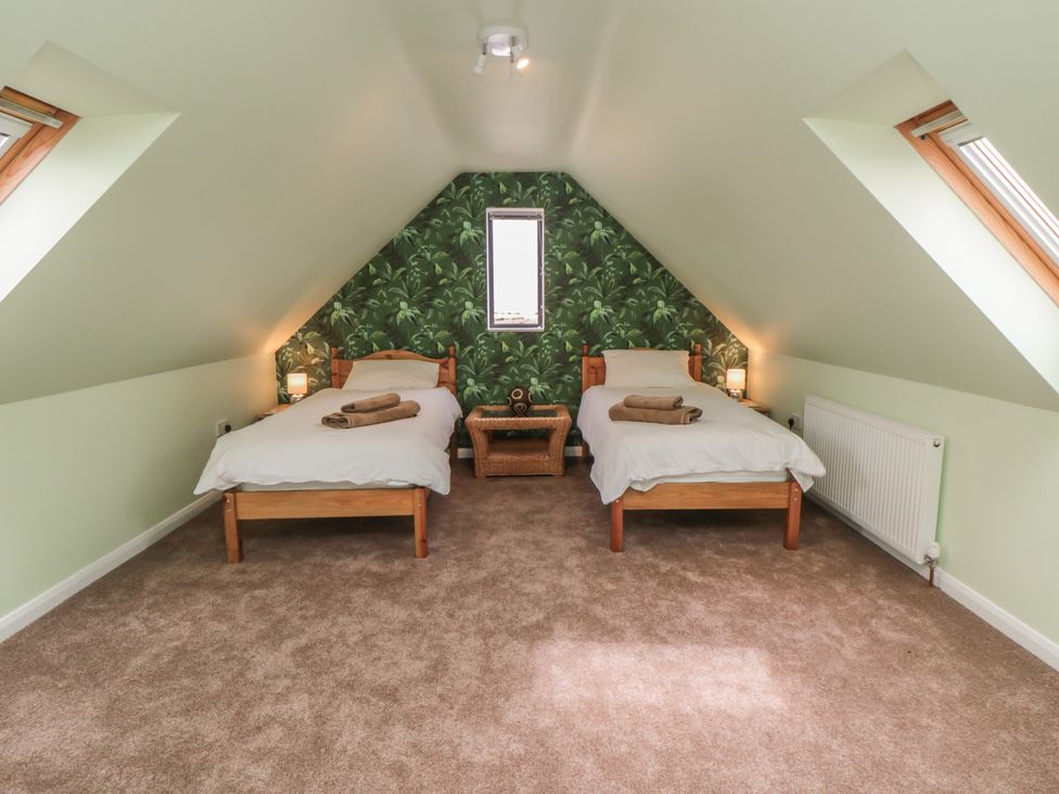 A bedroom with two beds and a window at Bay View