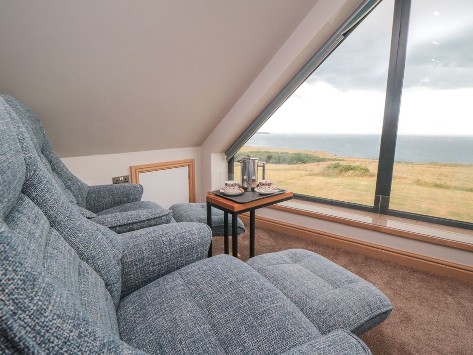 A living room with recliner chairs and a view at Bay View