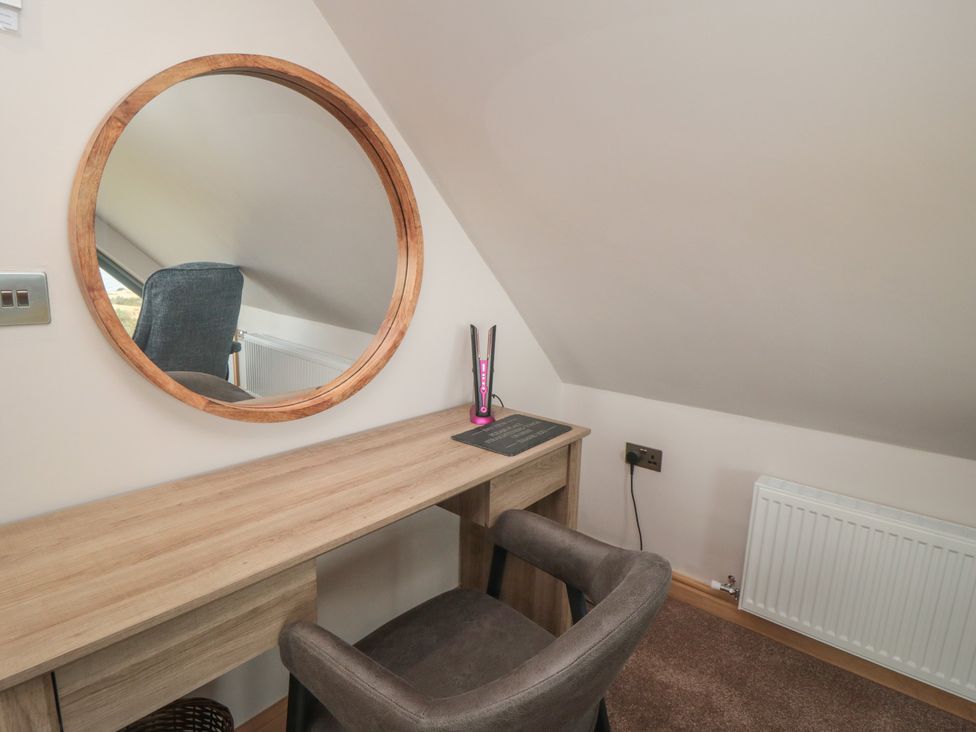 A home office with a desk and mirror at Bay View