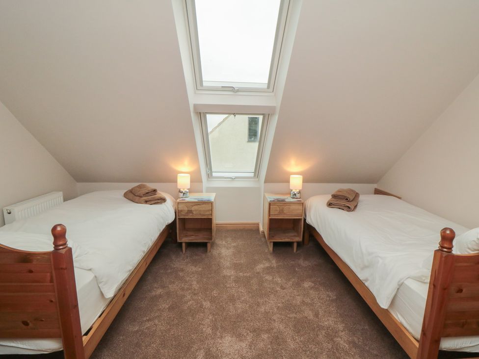 A bedroom with two beds and windows at Bay View