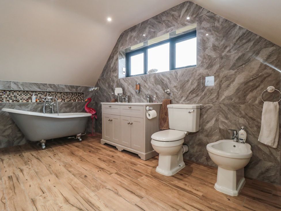 A bathroom with a bathtub and vanity at Bay View