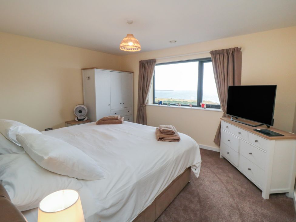 A bedroom with a bed and television at Bay View