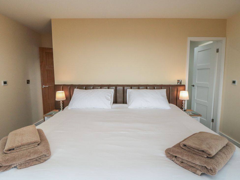 A bedroom with a bed and nightstands at Bay View