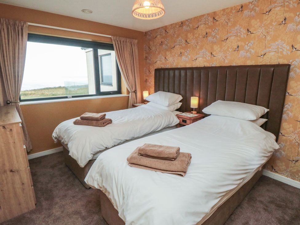 A bedroom with two beds and a view at Bay View