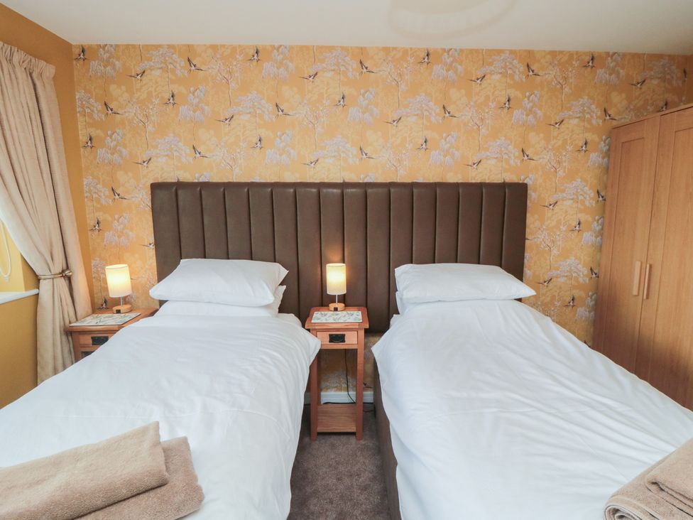 A bedroom with two beds and nightstands at Bay View 