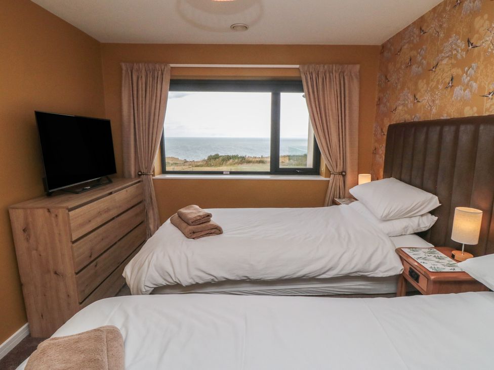 A bedroom with two beds and a TV at Bay View