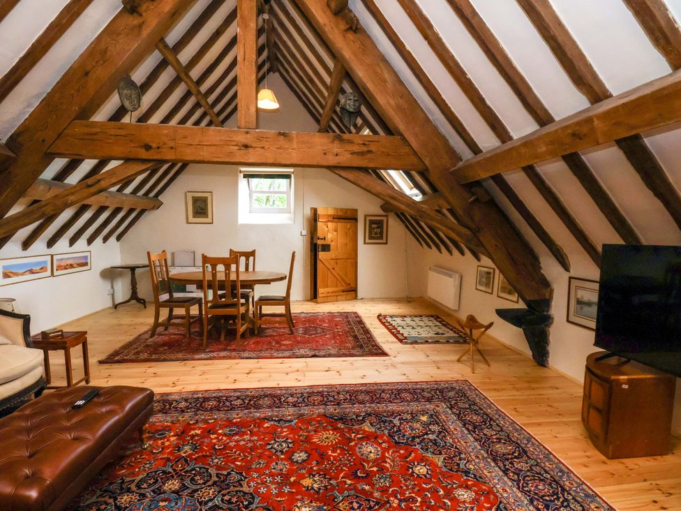 A living room with a dining table and sofa at The Gardener's Cottage, Low Hall, Scarborough