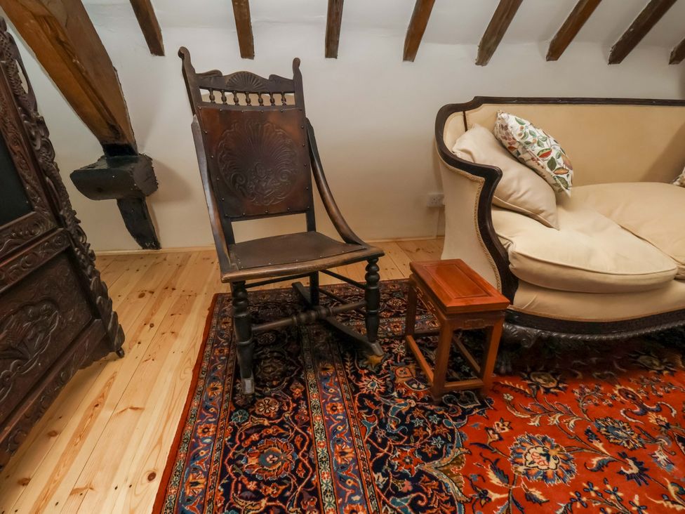 A living room with a chair and sofa at The Gardener's Cottage, Low Hall Scarborough