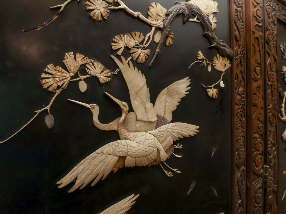 A decorative panel featuring cranes and floral motifs at The Gardener's Cottage, Low Hall Scarborough