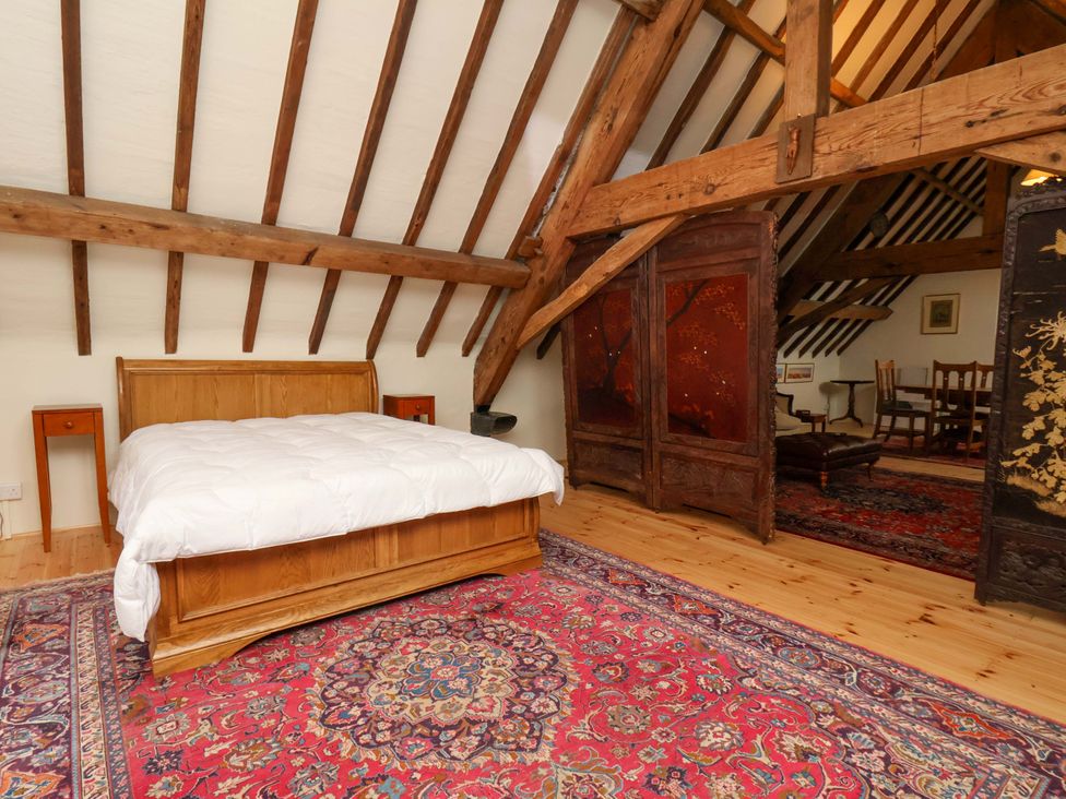 A bedroom with a bed and a rug at The Gardener's Cottage, Low Hall Scarborough