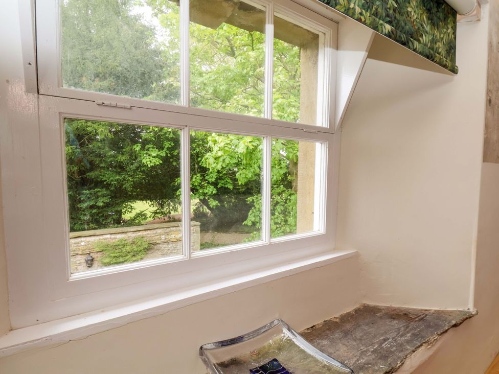 A window with a view of greenery at The Gardener's Cottage, Low Hall in Scarborough