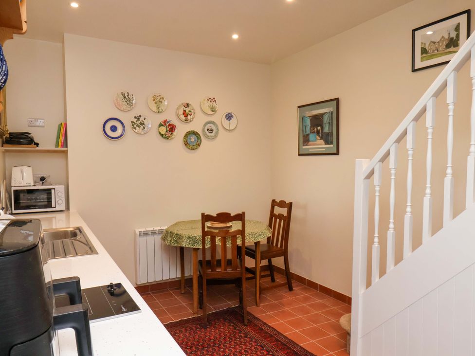 A kitchen with a dining table and chairs at The Gardener's Cottage, Low Hall in Scarborough