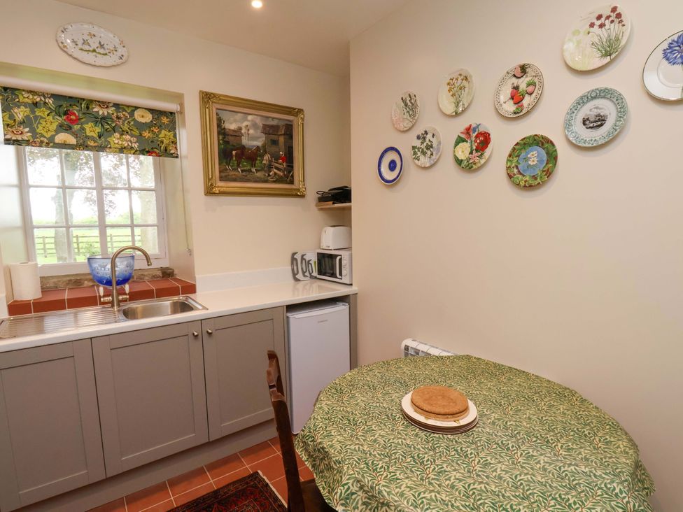 A kitchen with sink and appliances at The Gardener's Cottage, Low Hall in Scarborough