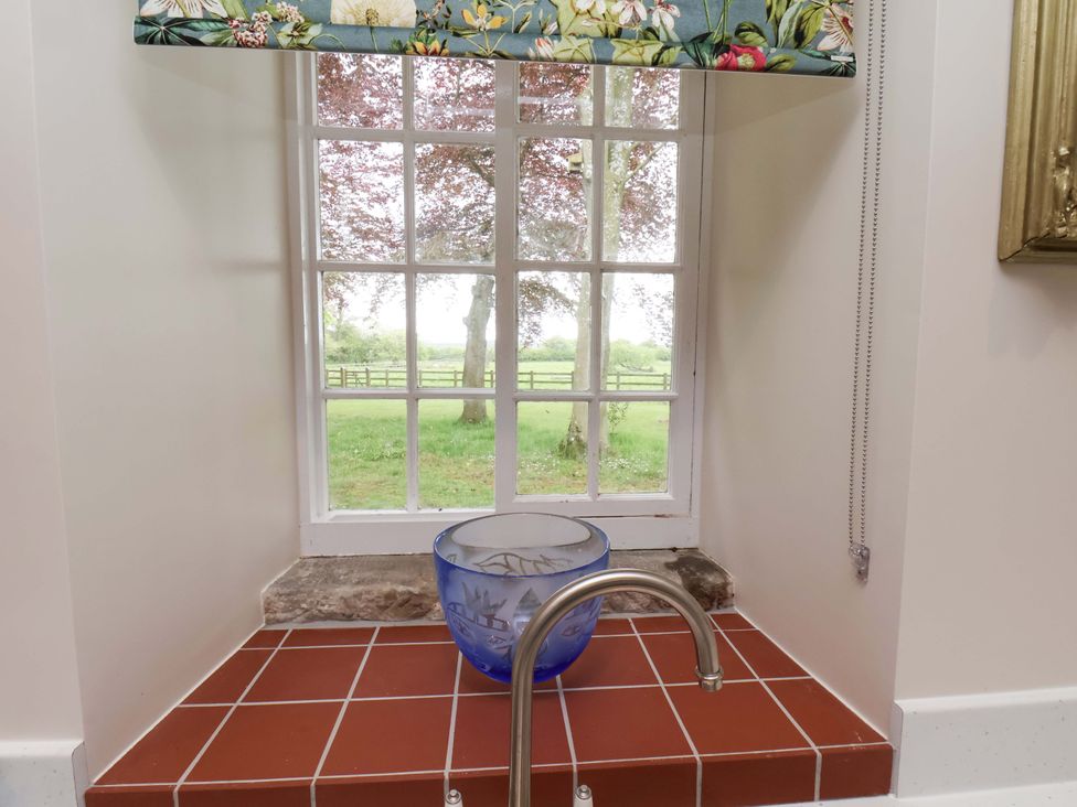 A window with a bowl and sink under it at The Gardener's Cottage, Low Hall in Scarborough