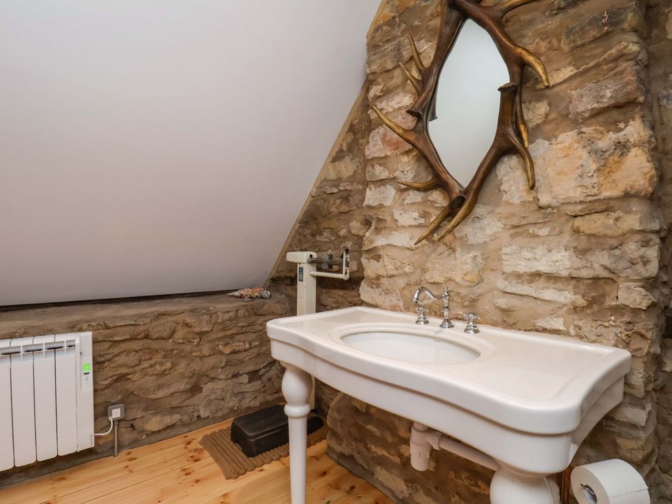 A bathroom with a sink and mirror at The Gardener's Cottage, Low Hall Scarborough