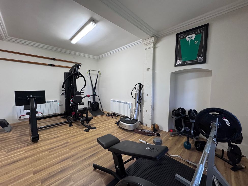 A gym with exercise equipment and weights at The Gardener's Cottage, Low Hall Brompton-By-Sawdon