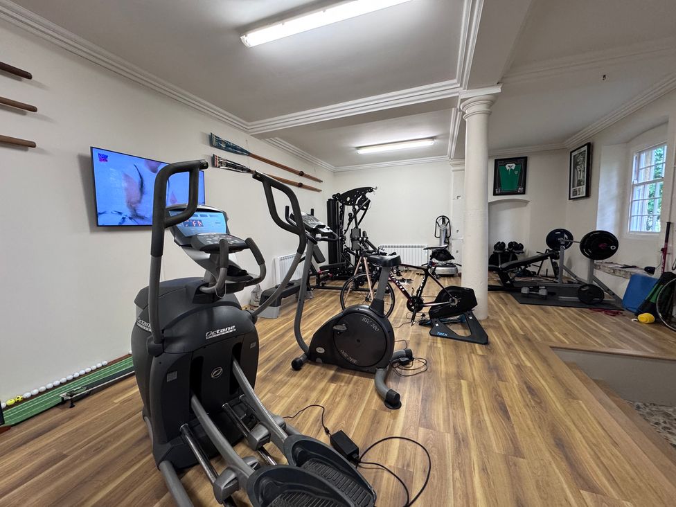 A gym with various exercise equipment at The Gardener's Cottage, Low Hall Brompton-By-Sawdon