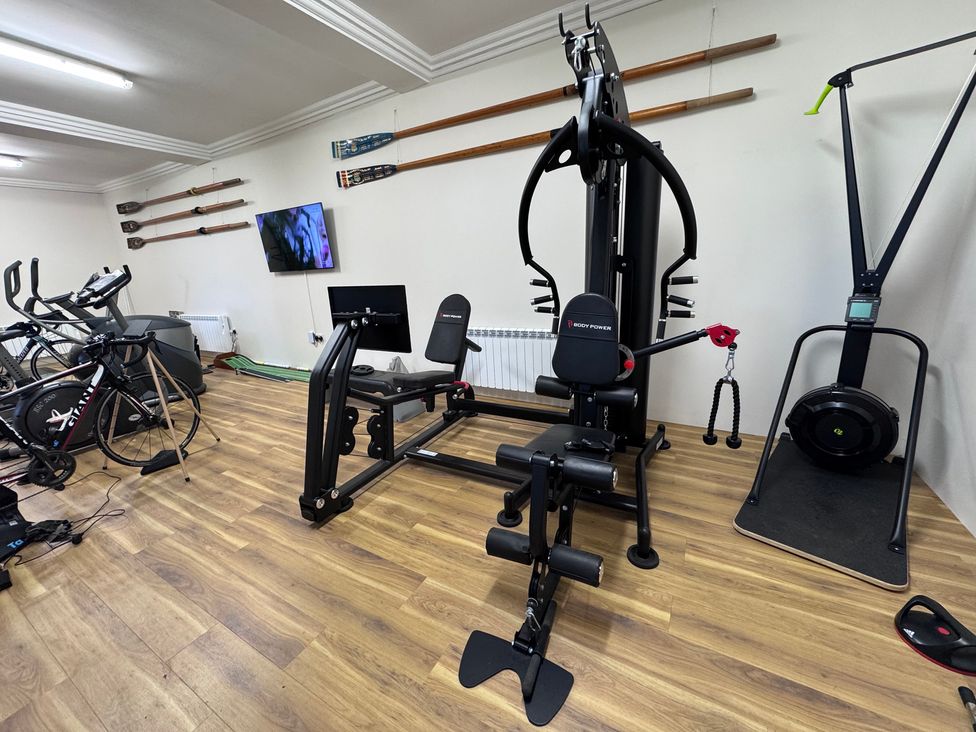 A gym with exercise equipment and a television at The Gardener's Cottage, Low Hall Brompton-By-Sawdon
