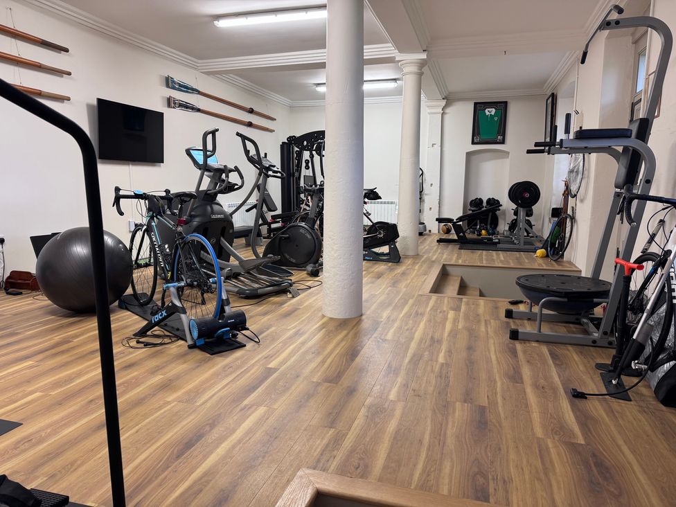 A gym with various fitness equipment and a television at The Gardener's Cottage, Low Hall Brompton-By-Sawdon