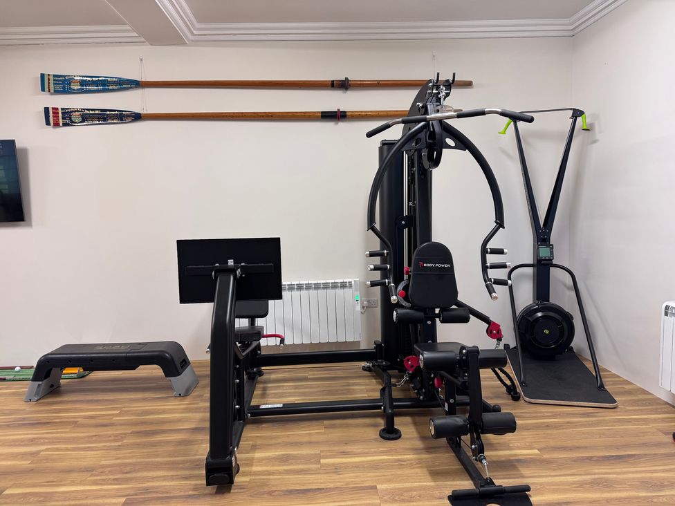 A gym with exercise equipment and rowing oars at The Gardener's Cottage, Low Hall Brompton-By-Sawdon
