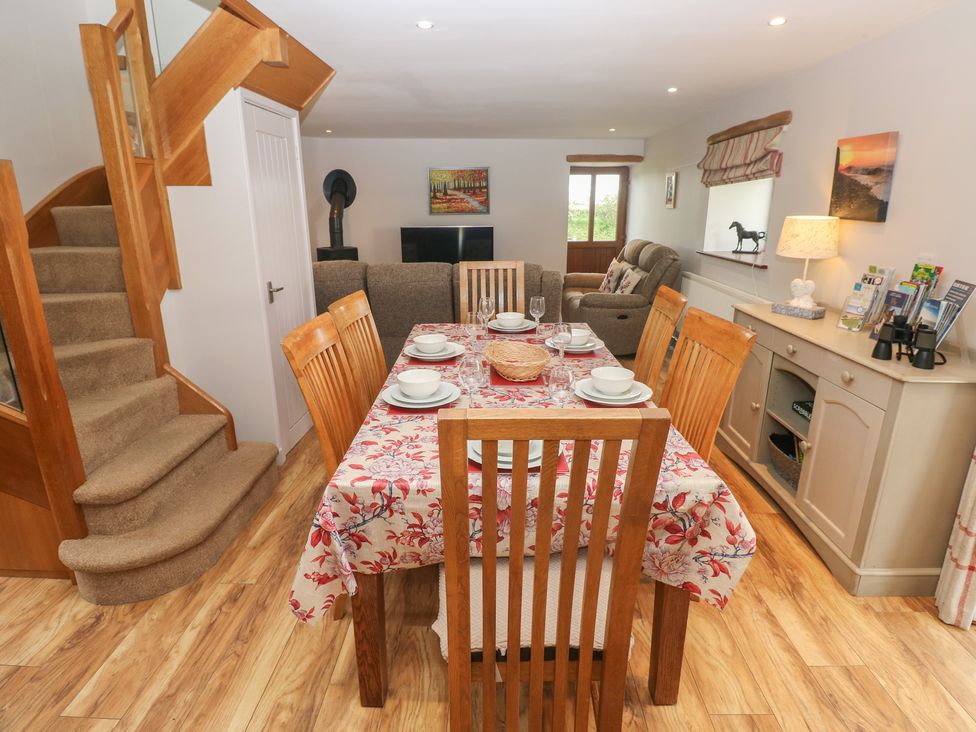 A dining room with table and chairs at The Gallops in Barry