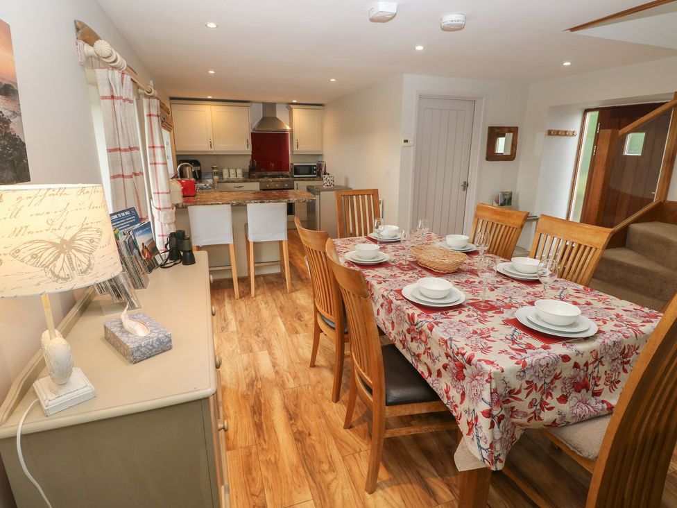 A dining room with a table set for meals at The Gallops in Barry