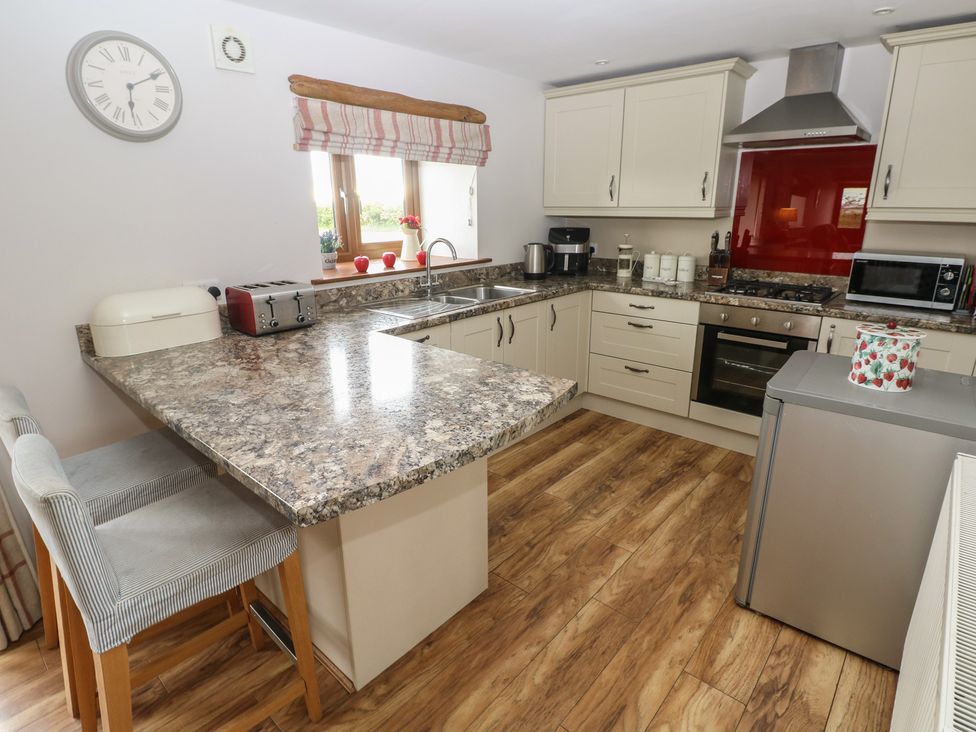 A kitchen with appliances and a countertop at The Gallops in Barry
