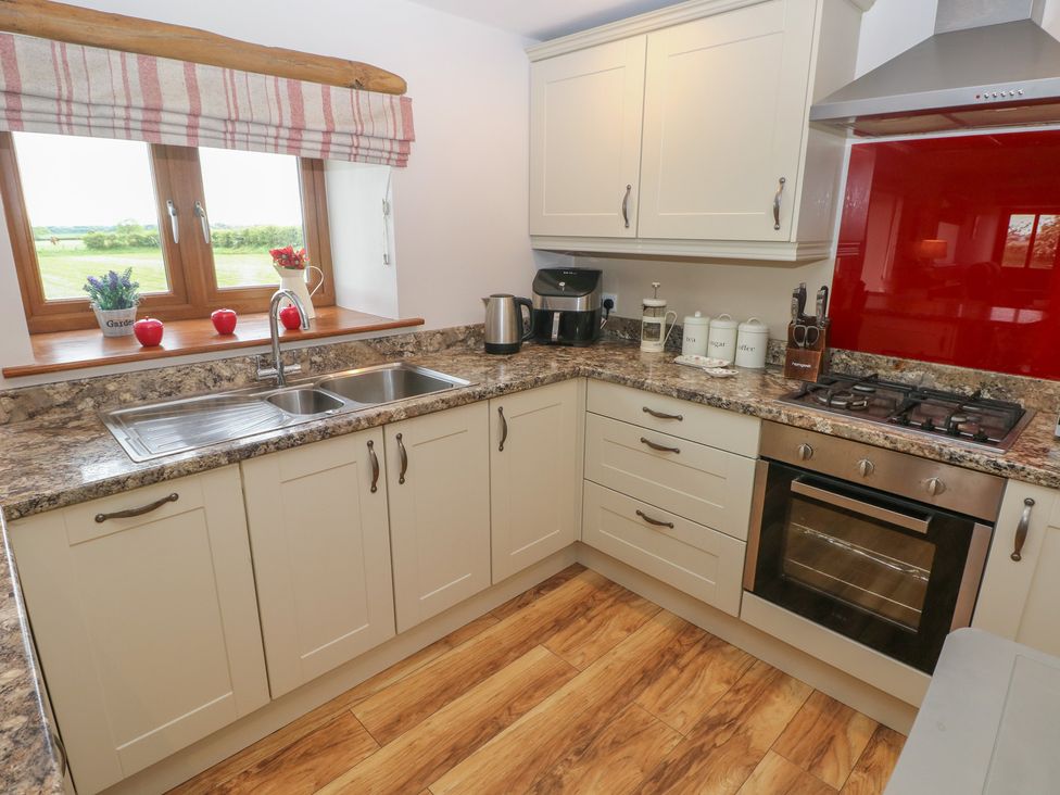 A kitchen with a sink and cupboards at The Gallops in Barry
