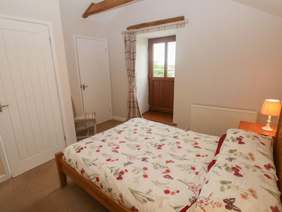 A bedroom with a bed and window at The Gallops in Barry
