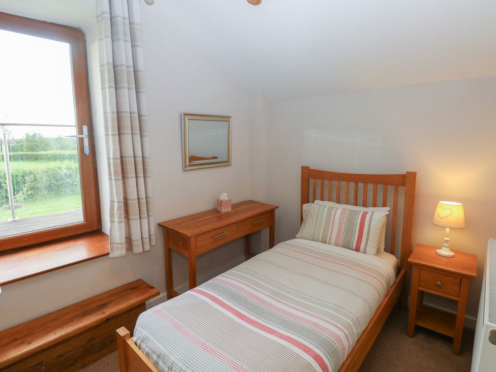 A bedroom with a single bed and a window at The Gallops in Barry