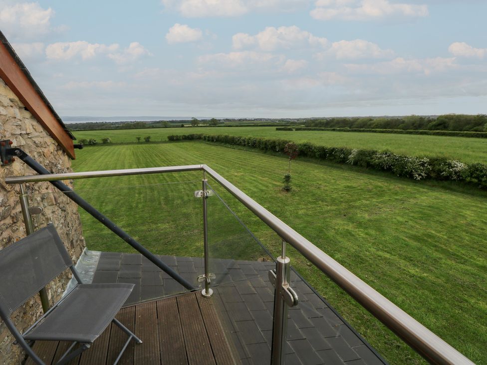 A balcony overlooking a grassy field at The Gallops in Barry