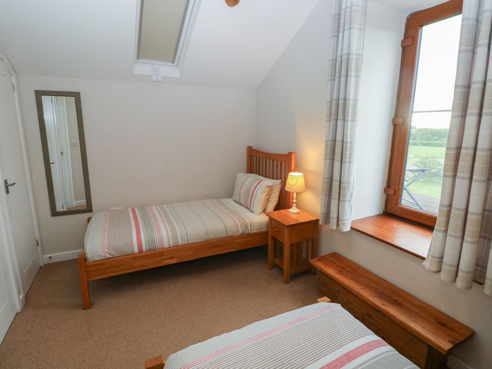 A bedroom with two beds and a window at The Gallops in Barry