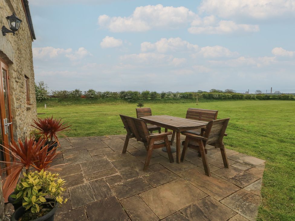 An outdoor dining area with a table and chairs at The Gallops in Barry