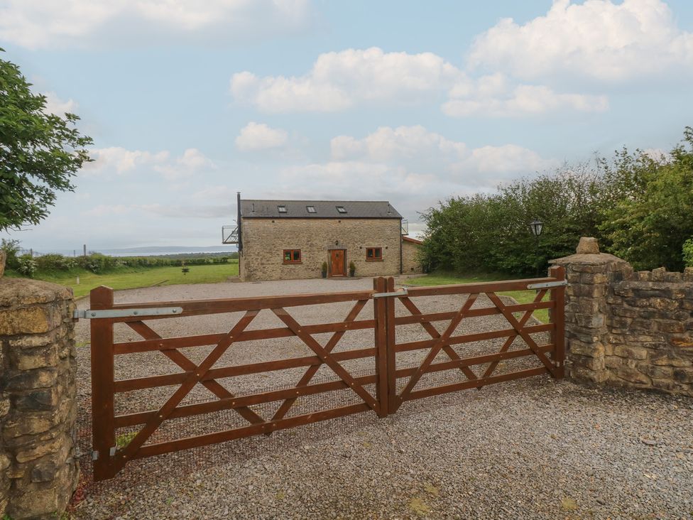 A house with a gravel driveway and gate at The Gallops in Barry