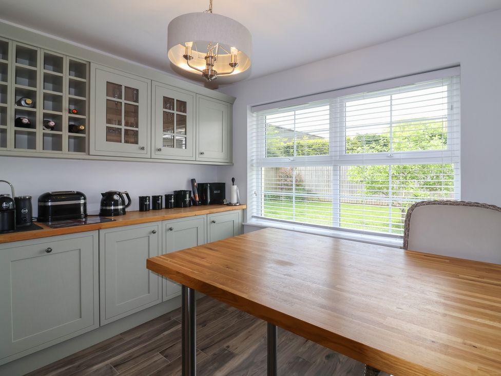 A kitchen with cabinets, appliances and a window at Villina in Somerton