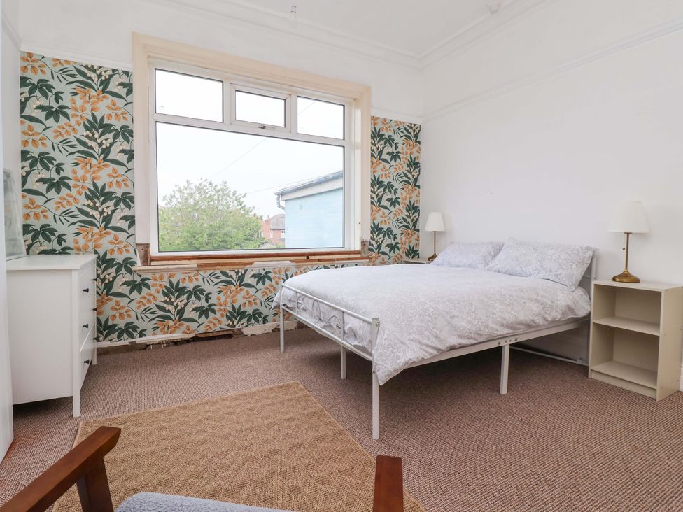 A bedroom with a bed, lamp, and dresser at 72 South Marine Drive Bridlington