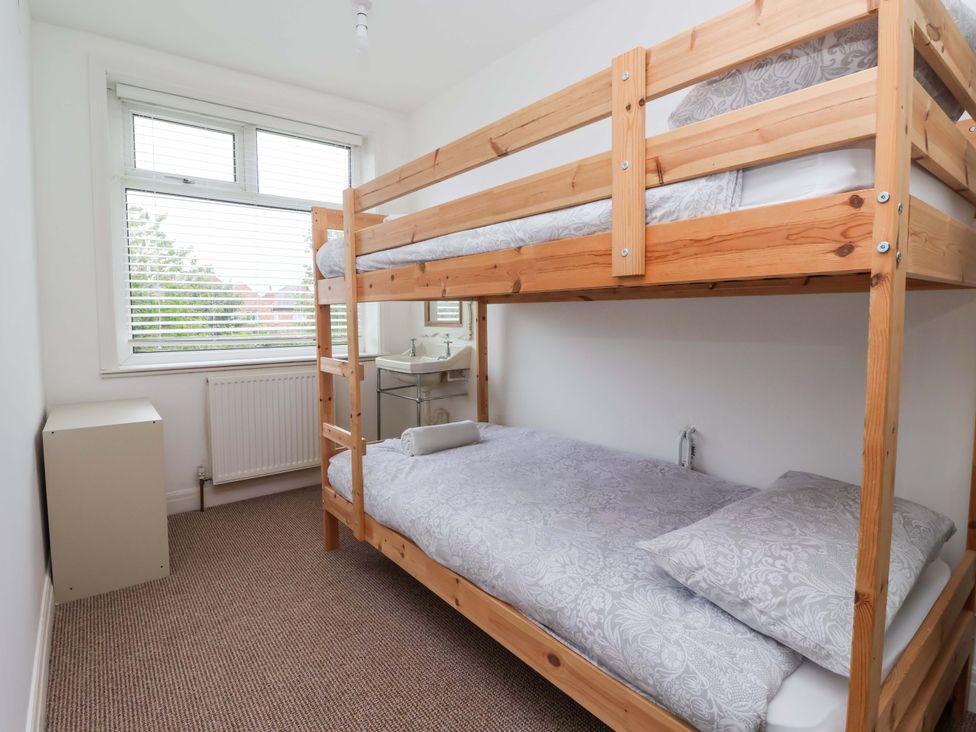 A bedroom with a bunk bed and a desk at 72 South Marine Drive Bridlington