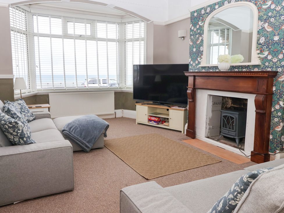 A living room with a tv and fireplace at Sunrise Lodge in Bridlington
