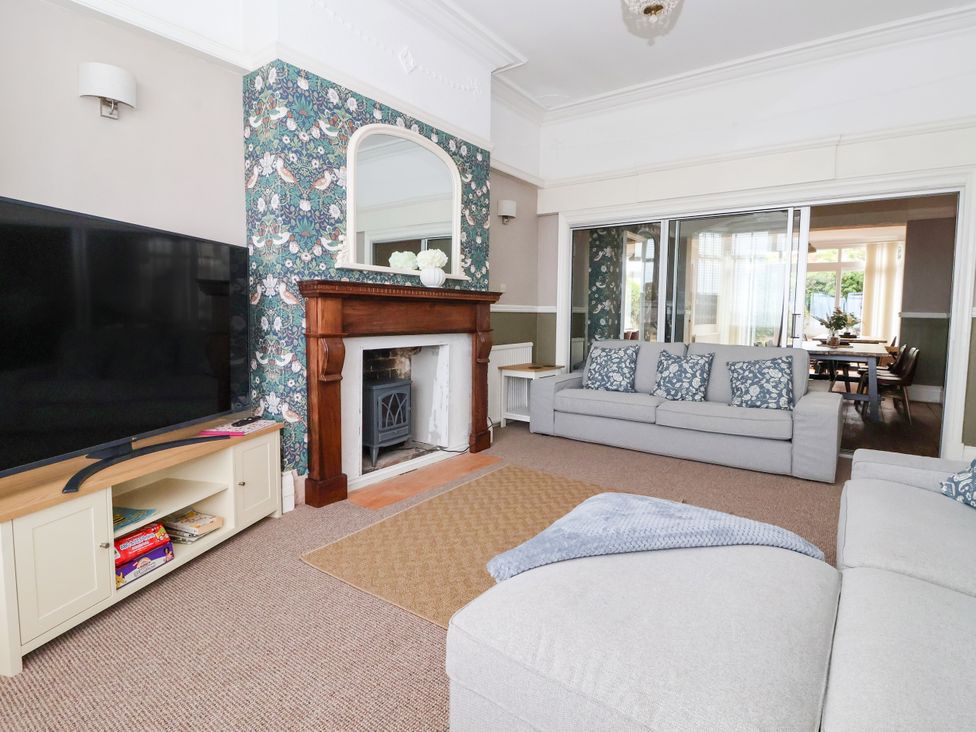A living room with a television and fireplace at Sunrise Lodge in Bridlington