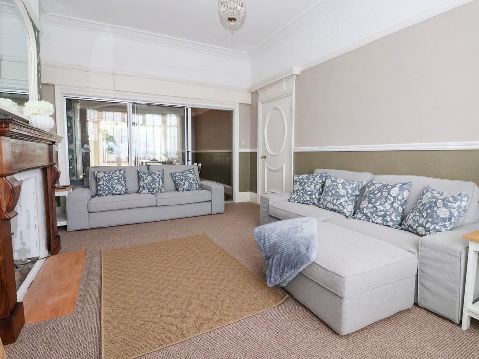 A living room with a sofa and fireplace at Sunrise Lodge in Bridlington