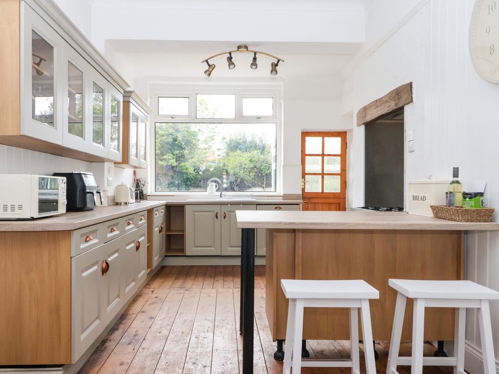 A kitchen with cabinets and a sink at Sunrise Lodge in Bridlington