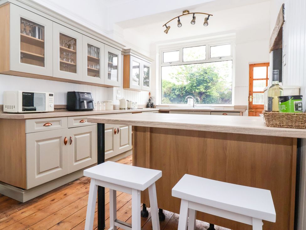 A kitchen with cabinets and appliances at Sunrise Lodge in Bridlington