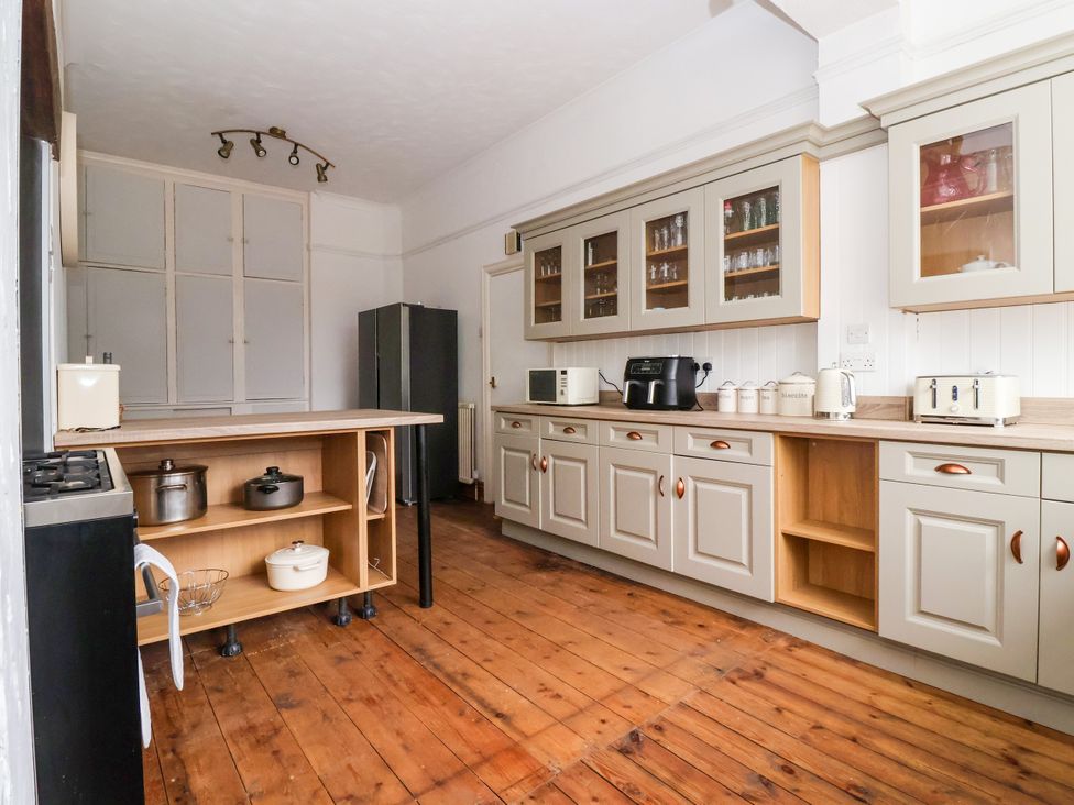 A kitchen with appliances and wooden counters at Sunrise Lodge in Bridlington