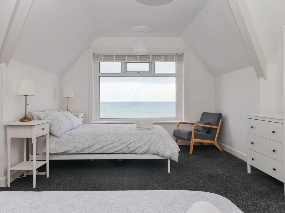 A bedroom with a bed and dresser at Sunrise Lodge in Bridlington