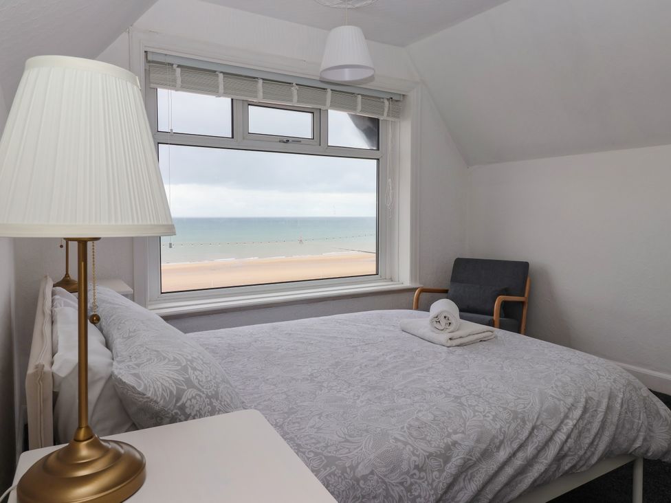 A bedroom with a bed and window view at Sunrise Lodge in Bridlington