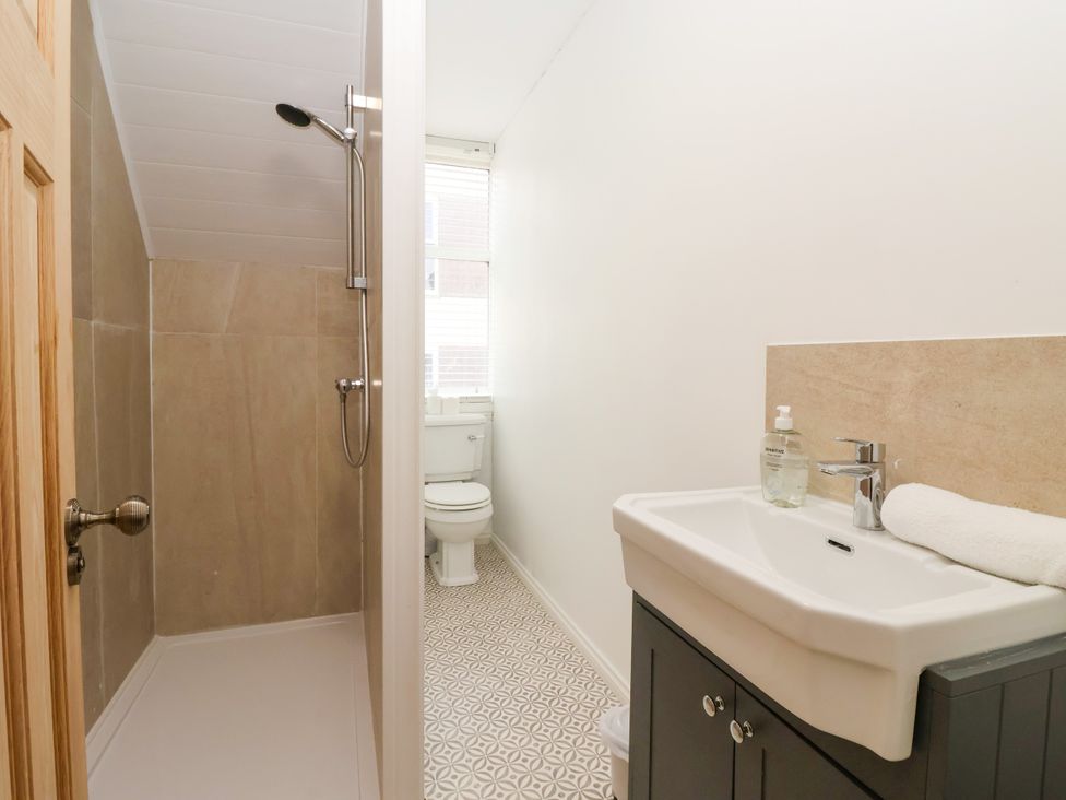 A bathroom with a shower, toilet and sink at Sunrise Lodge in Bridlington