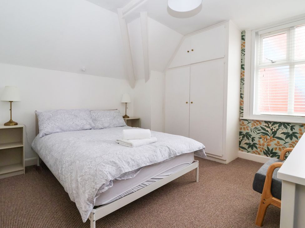 A bedroom with a bed and nightstands at Sunrise Lodge in Bridlington