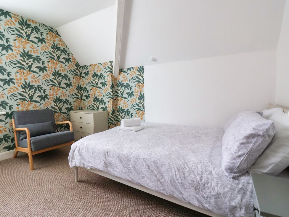 A bedroom with a bed and armchair at Sunrise Lodge in Bridlington