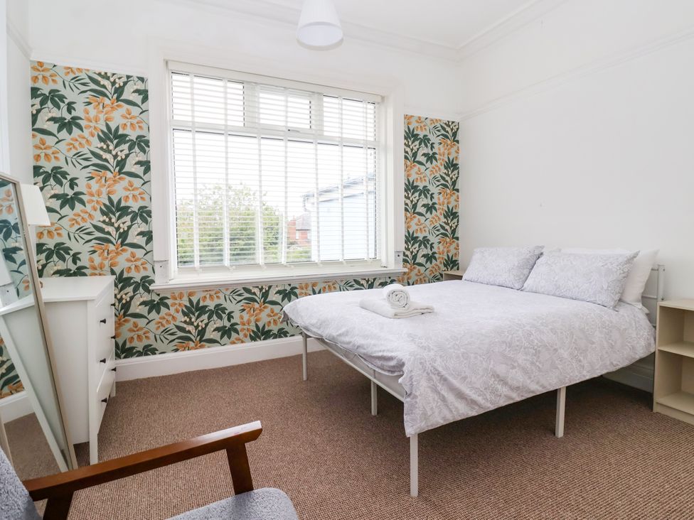 A bedroom with a bed and mirror at Sunrise Lodge in Bridlington