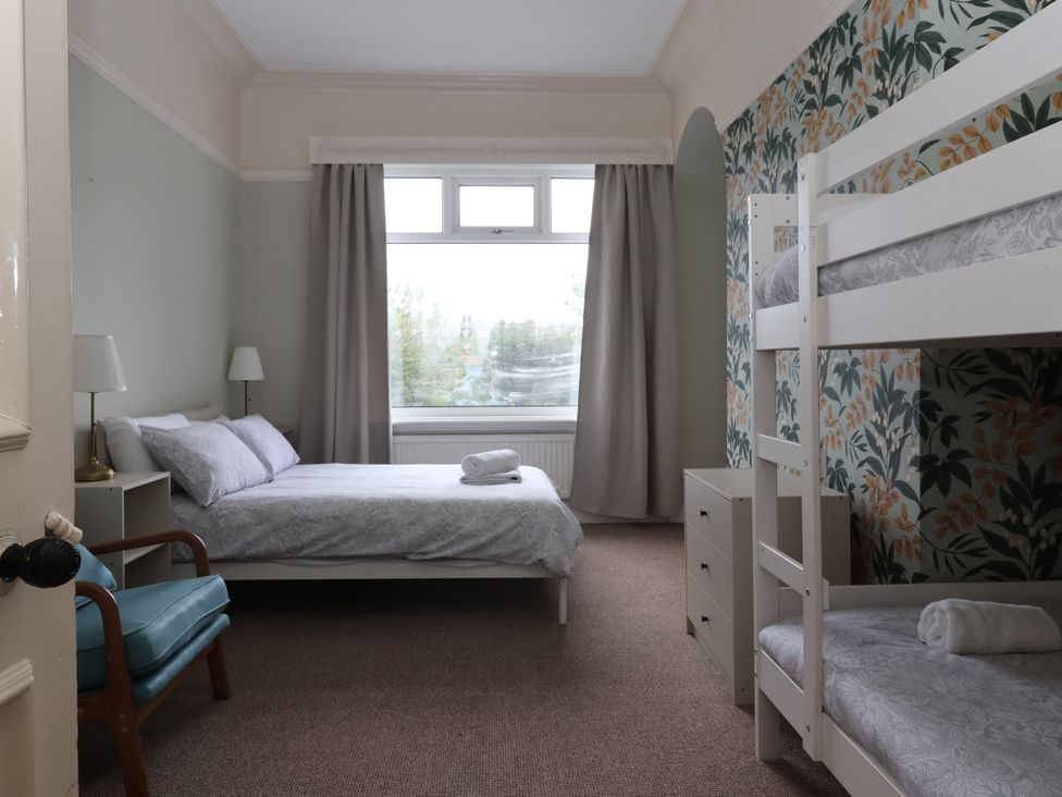 A bedroom with a double bed and a bunk bed at Sunrise Lodge in Bridlington
